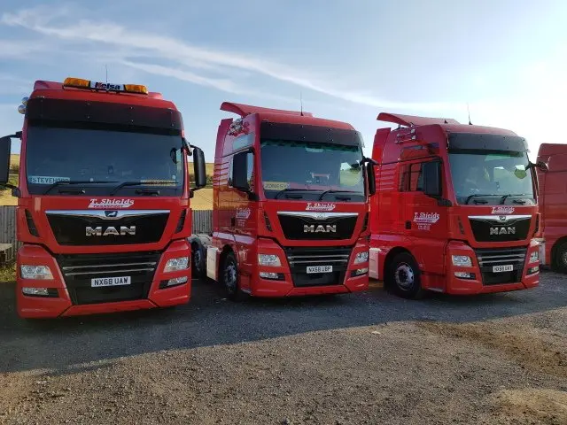 Three red MAN tractor units used on haulage contracts T Shields Transport