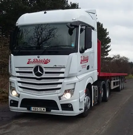 White Mercedes Actros with red flatbed trailer T Shields Transport
